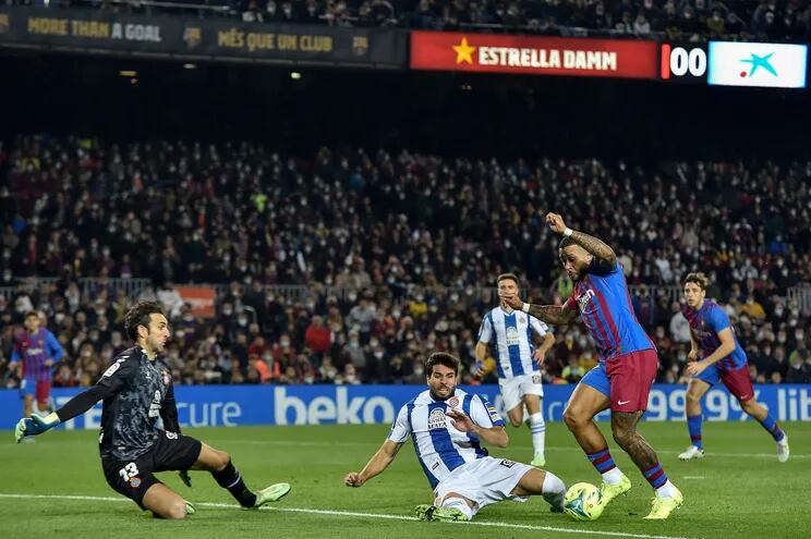 La jugada del polémico penal para Barcelona. Leandro Cabrera se tira para rechazar el balón de los pies de Memphis Depay.