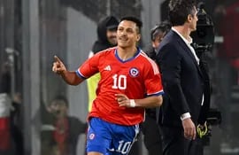Chile's forward Alexis Sanchez celebrates an own goal scored by Paraguay's goalkeeper Antony Silva during the friendly football match between Chile and Paraguay, at the Monumental David Arellano stadium in Santiago on March 27, 2023. (Photo by MARTIN BERNETTI / AFP)