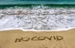vacaciones playa covid arena coronavirus tapabocas