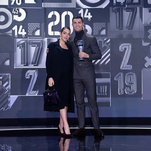 Hermosa pareja. Georgina Rodríguez y Cristiano Ronaldo, felices con el nuevo trofeo que llevaron a su hogar.