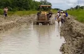 Personal y maquinarias de las estancias Profecía y Techapora desaguando el camino inundado que conduce a los distritos de Fuerte Olimpo y Bahía Negra.