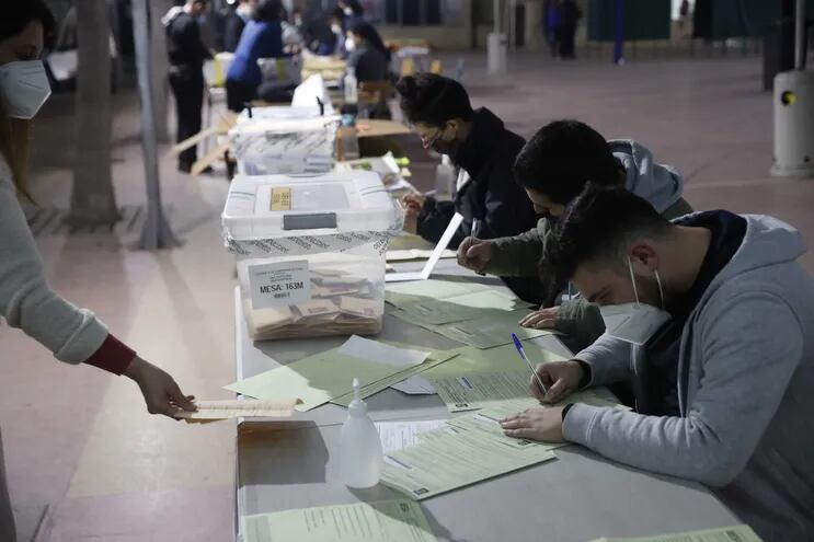 Funcionarios cierran las urnas e inician el conteo de votos hoy, en el cierre de las elecciones locales y constituyentes, en Santiago de Chile. Chile elige a los 155 ciudadanos que redactarán una nueva Constitución que reemplace a la actual, promulgada en dictadura.
