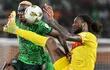 TOPSHOT - Angola's defender #6 Kialonda Gaspar (R) fights for the ball with Nigeria's forward #9 Victor Osimhen during the Africa Cup of Nations (CAN) 2024 quarter-final football match between Nigeria and Angola at the Felix Houphouet-Boigny Stadium in Abidjan on February 2, 2024. (Photo by Issouf SANOGO / AFP)