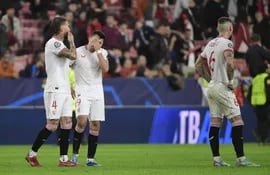 Los futbolistas del Sevilla lamentan la derrota ante el PSV y eliminación de la Champions League en el estadio Ramón Sánchez-Pizjuán, en Sevilla, España.