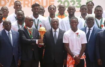 Abidjan (Cote D''ivoire), 13/02/2024.- President of the Ivorian soccer Federation Yacine Idriss Diallo (C-L) and President of Ivory Coast Alassane Ouattara (C-R) hold the Africa Cup of Nations trophy as they pose for a photo with the Ivory Coast soccer team during a reception at the Presidential Palace in Abidjan, Ivory Coast, 13 February 2024. Ivory Coast on 11 February won the CAF 2023 Africa Cup of Nations final against Nigeria. (Costa de Marfil) EFE/EPA/LEGNAN KOULA
