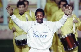Pelé abre los brazos mientras agradece los vítores de una multitud de espectadores el 31 de octubre de 1990 durante una ceremonia en Milán para celebrar su quincuagésimo cumpleaños. - Un partido amistoso entre Brasil y el equipo World Soccer Stars siguió a la ceremonia.