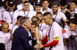 Javier Díaz de Vivar, vicepresidente de la Asociación Paraguaya de Fútbol (APF), entrega hoy el trofeo del Torneo Apertura 2022 al capitán Óscar Cardozo de Libertad.