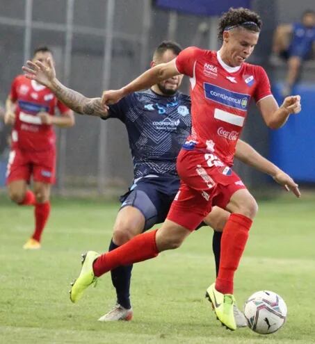 Avance de Carlos Niño Junior Espínola, defensor tricolor,  ante la marca de Rodrigo Alborno, durante el partido principal.