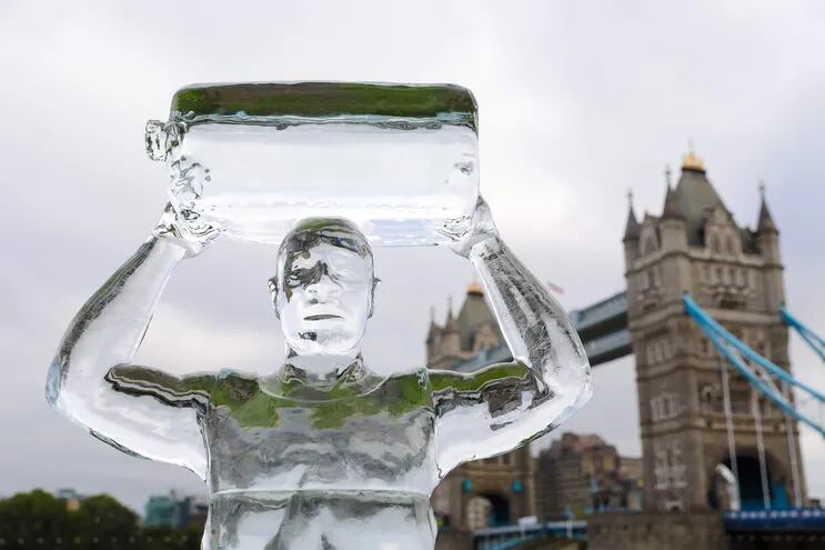 Una escultura en hielo imita a una persona que camina en busca de agua, emplazada cerca del Tower Bridge sobre el río Támesis en Londres.