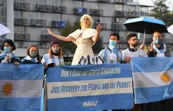 Una activista de Avaaz representa a Evita Perón en una protesta frente a la COP26.