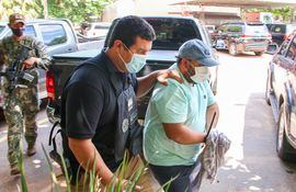 Fernando Enrique Balbuena Acuña, llegando ayer esposado a la sede de la Senad, custodiado por un agente antidrogas.