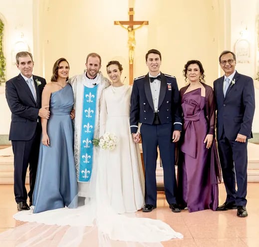 En la foto, los novios, sus padrinos y el sacerdote.