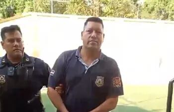 El guardiacárcel Nicolás Ovelar Toledo esposado, es conducido por un efectivo policial al calabozo de la comisaría 4ª de Asunción.
