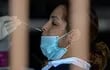 A health worker collects a nasal swab sample from a woman to be tested for COVID-19 at Las Acias neigborhood in Panama City, on July 16, 2020. - Panama exceeded 50,000 cases of COVID-19, from which some 1000 people have died. Due to an increase of contagions, the Ministry of Health announced that full quarantine will be resumed on weekends, a measure that had been lifted in early June. (Photo by Luis ACOSTA / AFP)