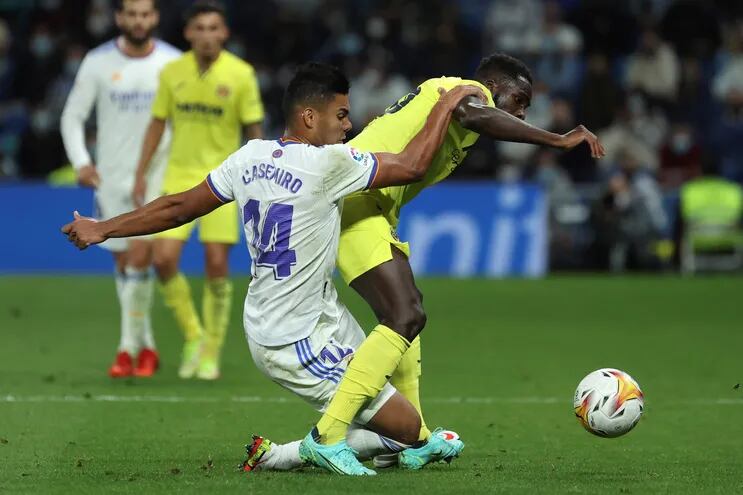 El delantero francés del Villarreal, Boulaye Dia (d), disputa el balón ante el centrocampista brasileño del Real Madrid, Casemiro, durante el encuentro correspondiente a la séptima jornada de primera división disputado hoy sábado en el estadio Santiago Bernabéu, en Madrid.
