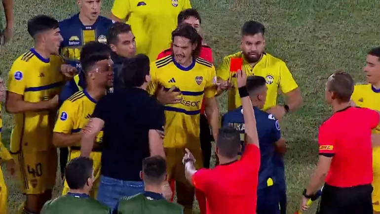 El paraguayo José Arrúa (remera negra) recibe la tarjeta roja después de discutir con Edinson Cavani y empujar a Miguel Merentiel.