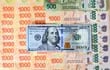 Un billete de 100 dólares estadounidense junto a otros de la moneda argentina. (AFP)