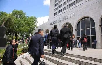 Reingreso de funcionarios al Palacio de Justicia de Asunción tras descartarse la existencia de una bomba.