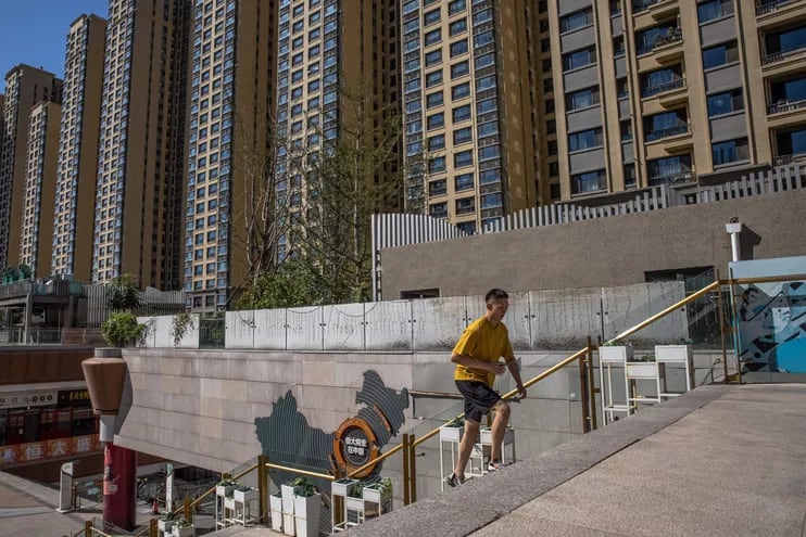 Un hombre camina en las cercanías del complejo inmobiliario construido por la compañía Evergrande, en China. (EFE/EPA/ROMAN PILIPEY)