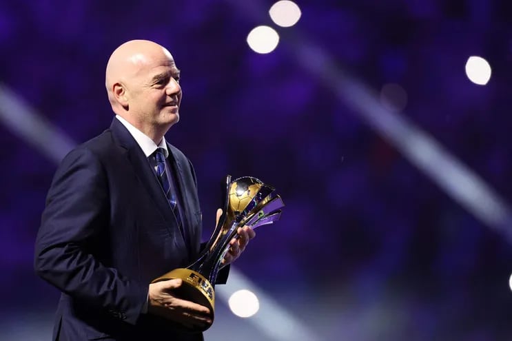 FIFA President Gianni Infantino walks to present the winner's trophy to Manchester City during the presentation ceremony at the end of the FIFA Club World Cup 2023 football final match between England's Manchester City and Brazil's Fluminense at King Abdullah Sports City Stadium in Jeddah on December 22, 2023. (Photo by Giuseppe CACACE / AFP)