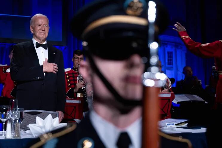US President Joe Biden listens to the US national anthem during the White House Correspondents' Association (WHCA) dinner at the Washington Hilton, in Washington, DC, on April 27, 2024. (Photo by Brendan Smialowski / AFP)