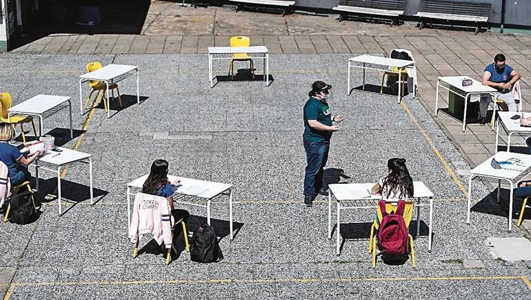 Estudiantes, argentinos, usando tapabocas y respetando la distancia para evitar la propagación del covid.