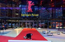Un trabajador extiende la alfombra roja frente al Berlinale Palast, donde desde mañana se realizará la 73 edición del Festival de Cine de Berlín.