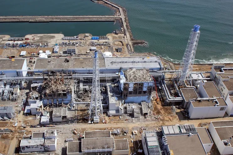 (FILES) This aerial handout photo taken by an unmanned aerial vehicle (UAV) from the Air Photo Service on March 24, 2011 shows Tokyo Electric Power Co (TEPCO) Fukushima Daiichi No.1 nuclear power plant, with the damaged fourth reactor (R) and the damaged third reactor (L), in the town of Okuma in Fukushima prefecture, following the earthquake and tsunami which hit the region on March 11, 2011. - Ten years after the Fukushima disaster, Japan's nuclear industry remains crippled, with the majority of the country's reactors halted or on the path towards decommissioning. (Photo by Handout / AIR PHOTO SERVICE / AFP) / TO GO WITH Japan-tsunami-nuclear-Fukushima-energy by Etienne BALMER
-----EDITORS NOTE --- RESTRICTED TO EDITORIAL USE - MANDATORY CREDIT "AFP PHOTO / AIR PHOTO SERVICE" - NO MARKETING - NO ADVERTISING CAMPAIGNS - DISTRIBUTED AS A SERVICE TO CLIENTS  - NO ARCHIVES / 