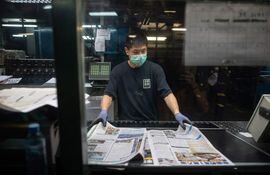 Un empleado del Apple Daily controla la impresión del periódico, que fue allanado por la policía hongkonesa, leal al régimen de Pekín. EFE/EPA/JEROME FAVRE.