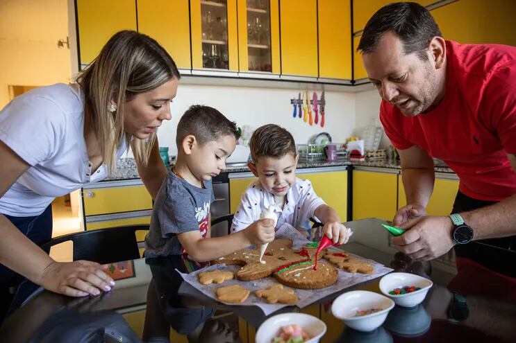 Denise Hutter y Aldo Franco junto a los niños Ignacio y Lucas, preparando delicias navideñas.