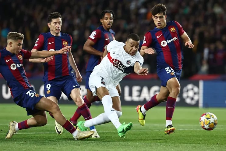 Paris Saint-Germain's French forward #07 Kylian Mbappe scores his second goal and his team's fourth goal during the UEFA Champions League quarter-final second leg football match between FC Barcelona and Paris SG at the Estadi Olimpic Lluis Companys in Barcelona on April 16, 2024. (Photo by FRANCK FIFE / AFP)