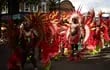 Performers in costume take part in the main parade of the Notting Hill Carnival in west London on August 27, 2023. (Photo by HENRY NICHOLLS / AFP)