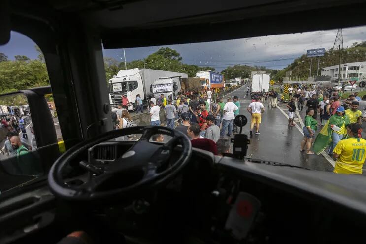 Personas protestan durante bloqueo de camioneros hoy, en la carretera Presidente Dutra, cerca a Volta Redonda (Brasil).  (EFE)
