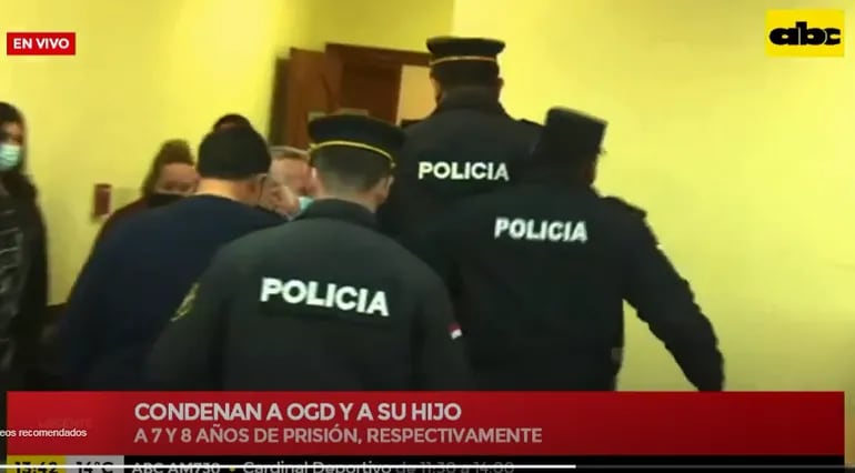 Captura de ABC TV. Momento en que Óscar González Daher (ANR-Cartista) se retira de la sala de juicios fuertemente custodiado por efectivos policiales y abucheado por varios ciudadanos.
