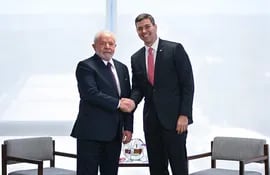 El presidente de Brasil, Luiz Inácio Lula da Silva (izq.), saluda el presidente electo de Paraguay, Santiago Peña, durante una reunión en el Palacio del Planalto, en Brasília, en mayo pasado. (Brasil). EFE/Andre Borges.