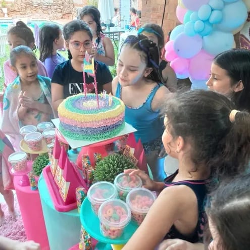 Luciana Arias a punto a apagar las velitas de su torta de cumpleaños, rodeada de sus amiguitas.