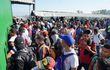 Migrantes hondureños esperan ser atendidos por autoridades del Instituto Nacional de Migración de México este sábado, luego de arribar al paso fronterizo con Guatemala de la Ciudad Hidalgo.