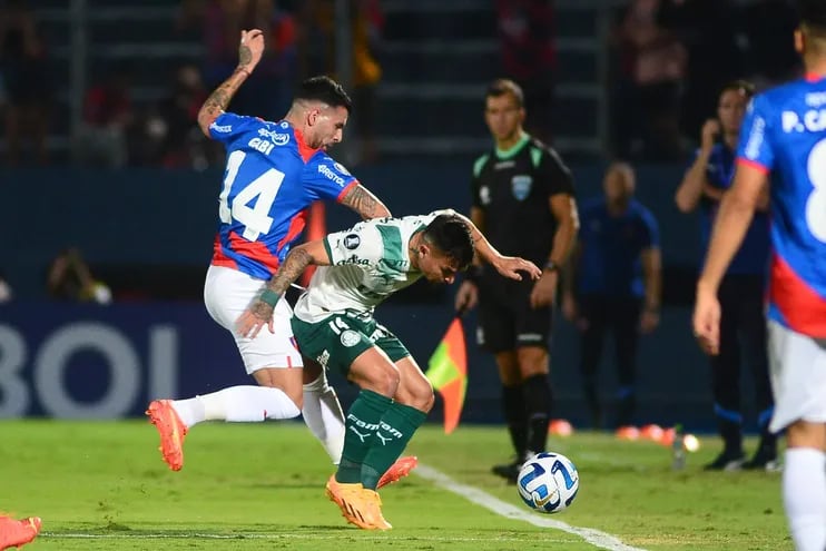 Gabriel Báez (i) de Cerro disputa el balón con Artur de Palmeiras en un partido de la fase de grupos de la Copa Libertadores entre Cerro Porteño y Palmeiras en el estadio General Pablo Rojas en Asunción (Paraguay).