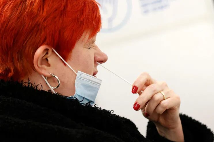 Una mujer toma una muestra para un análisis de covid-19 en un centro de testeo en Uxbridge, al oeste de Londres.