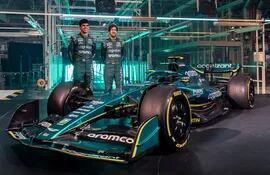A handout picture released by Aston Martin shows Aston Martin Formula One drivers Lance Stroll and Sebastian Vettel (R) posing with the new AMR22 car during its presentation at the global headquarters of Aston Martin Lagonda in Gaydon on February 10, 2022. (Photo by Handout / ASTON MARTIN / AFP) / RESTRICTED TO EDITORIAL USE - MANDATORY CREDIT "AFP PHOTO / ASTON MARTIN " - NO MARKETING - NO ADVERTISING CAMPAIGNS - DISTRIBUTED AS A SERVICE TO CLIENTS