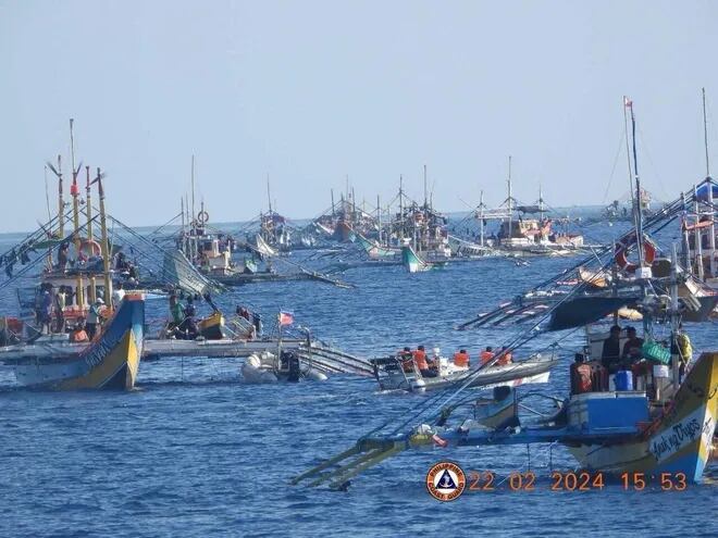 This handout photo taken on February 22, 2024 and received on February 25, 2024 from the Philippine Coast Guard shows China Coast Guard personnel onboard a rigid-hulled inflatable boat (centre R) shadowing a Philippine Bureau of Fisheries and Aquatic Resources (BFAR) inflatable boat (centre L) while it delivers supplies to fishermen during a mission led by the BRP Datu Sanday near the China-controlled Scarborough Shoal in the disputed South China Sea. The Philippines on February 25 accused the Chinese coast guard of attempting to block the Filipino government vessel BRP Datu Sanday delivering supplies to fishermen, the second such alleged incident near a disputed reef in two weeks. (Photo by Handout / Philippine Coast Guard (PCG) / AFP) / RESTRICTED TO EDITORIAL USE - MANDATORY CREDIT "AFP PHOTO / Philippine Coast Guard" - NO MARKETING NO ADVERTISING CAMPAIGNS - DISTRIBUTED AS A SERVICE TO CLIENTS