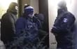 Policías con el rostro cubierto abren una puerta lateral del edificio donde la exterrorista Daniela Klette fue arrestada en Berlín, Alemania.
