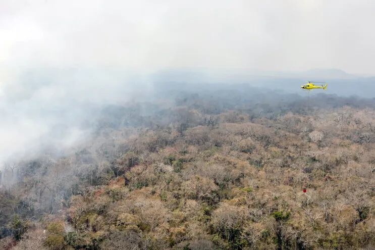 Un helicóptero sobrevuela una zona en llamas en la zona de San Ignacio de Velasco, en Santa Cruz, Bolivia.