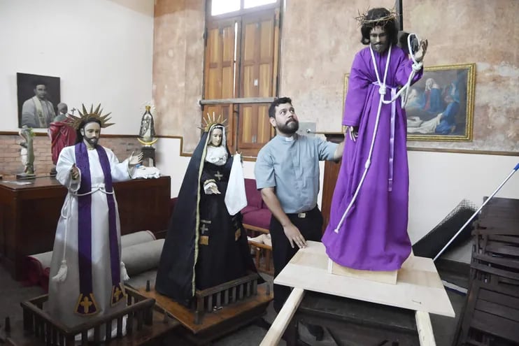 El padre Hugo Fernández acomoda la vestimenta de la imagen de Jesús crucificado en la iglesia La Encarnación, que se prepara para la vía crusis de la que participarán estacioneros de Ypané.