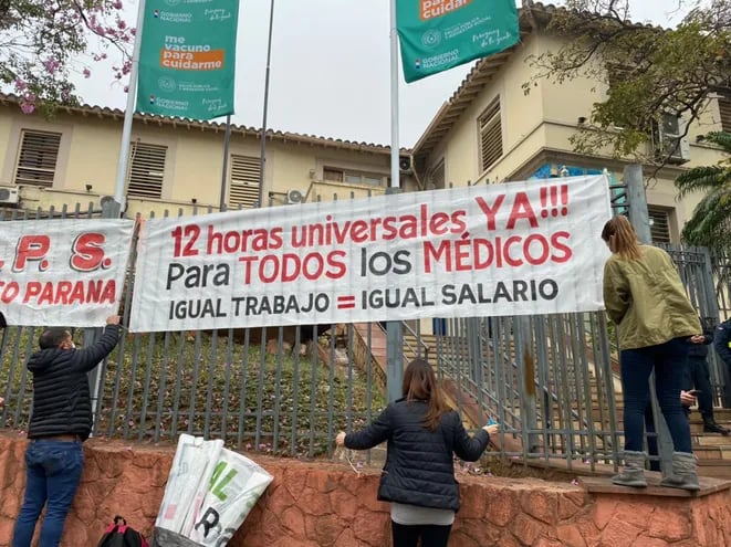 Médicos colocan carteles en las inmediaciones de la sede del Ministerio de Salud, en Asunción, este martes.