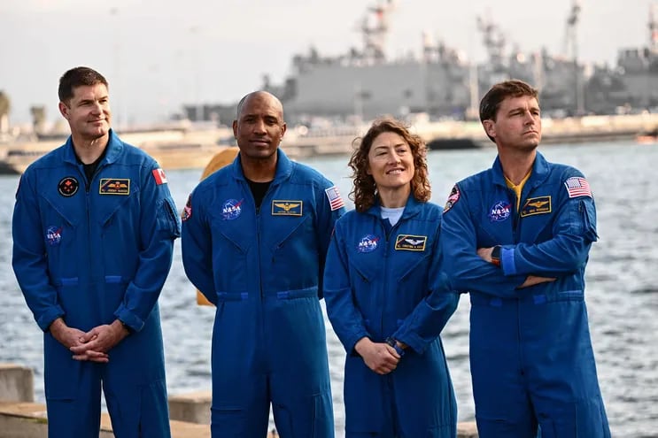 (L-R) Canadian Space Agency (CSA) astronaut Jeremy Hansen, NASA Astronaut Victor J. Glover, NASA Astronaut Christina Koch, and NASA Astronaut Reid Wiseman stand during a press conference about the Orion crew module test capsule outside the USS San Diego (LPD-22) at Naval Base San Diego following the Underway Recovery Test 11 in San Diego, California on February 28, 2024. In preparation for NASAs Artemis II crewed mission around the Moon, the Underway Recovery Test 11 allowed the testing of Orion spacecraft recovery procedures with the missions astronauts aboard during day and night recovery at sea. (Photo by Patrick T. Fallon / AFP)
