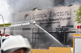 Volunteer firefighters try to extinguish a fire at the Superior Court of Electoral Justice (TSJE) headquarters in Asuncion on September 29, 2022. (Photo by NORBERTO DUARTE / AFP)
