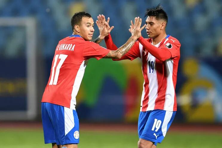 Paraguay's Alejandro Romero Gamarrra (L) celebrates with teammate Santiago Arzamendia after scoring against Bolivia during their Conmebol Copa America 2021 football tournament group phase match at the Olympic Stadium in Goiania, Brazil, on June 14, 2021. (Photo by EVARISTO SA / AFP)