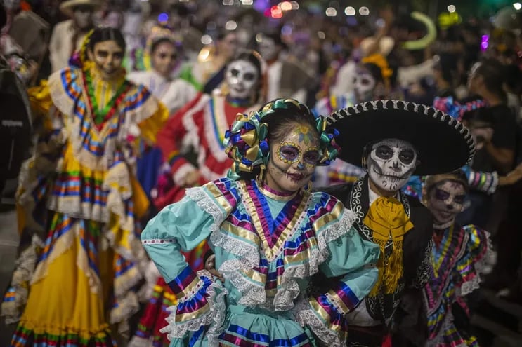 Personas caracterizadas de Catrinas y Catrines durante una procesión por el Día de Muertos en México. Las tradiciones de esta festividad mexicana serán celebradas hoy también en Asunción.