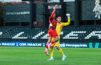 El delantero Elvio Vera celebra con el portero Víctor Rojas tras anotar el último penal de la tanda y certificar la clasificación de Libertad. (Foto: @CopaParaguayAPF)